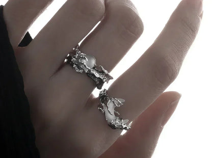 Silver ring with Moon and Sun design on a hand.